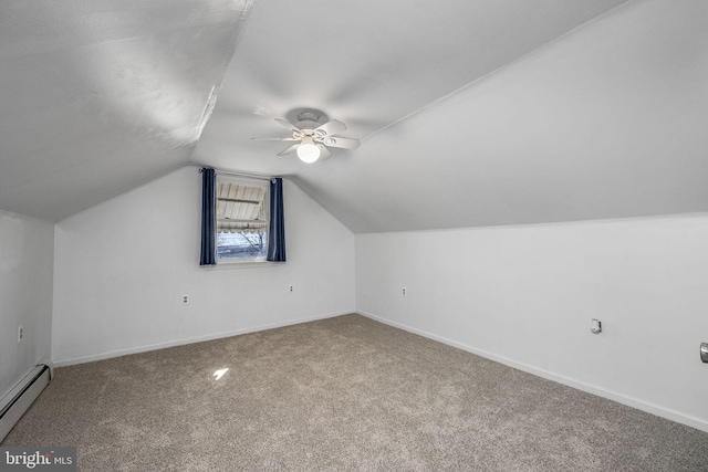 additional living space featuring a baseboard radiator, baseboards, lofted ceiling, and carpet