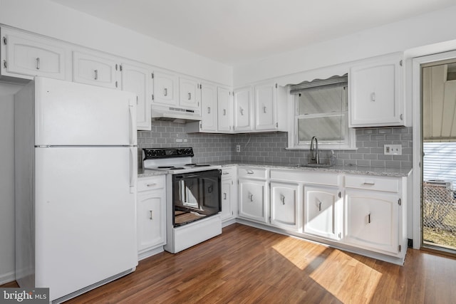 kitchen featuring under cabinet range hood, a sink, white cabinets, electric stove, and freestanding refrigerator