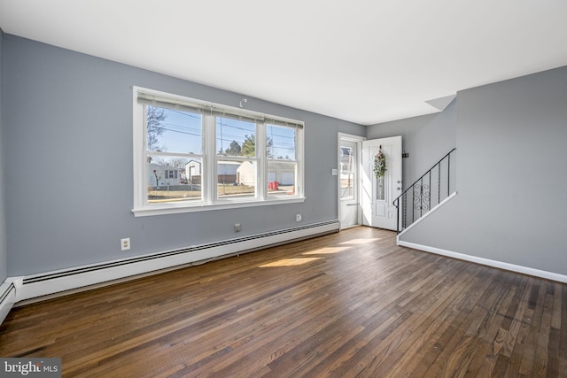 interior space featuring stairs, baseboard heating, hardwood / wood-style flooring, and baseboards