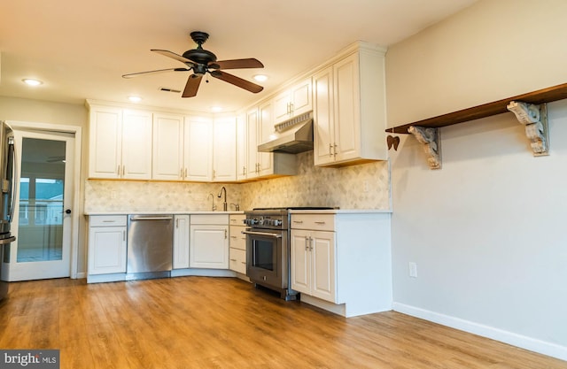 365 Heritage Way, Tuckerton, NJ 08087 - kitchen with decorative backsplash, light wood-style flooring, appliances with stainless steel finishes, under cabinet range hood, and a sink