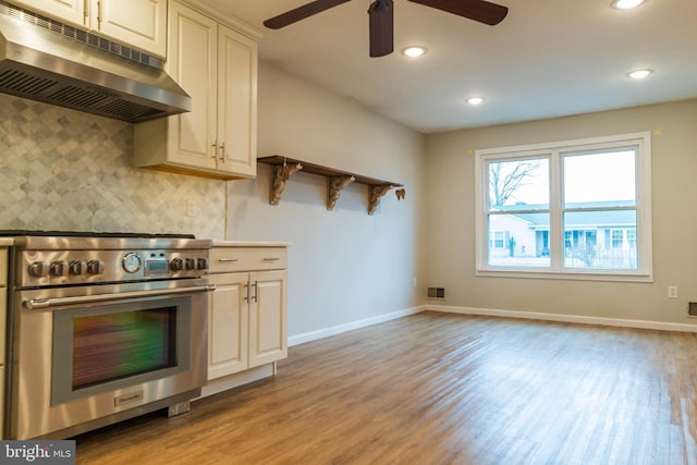 365 Heritage Way, Tuckerton, NJ 08087 - kitchen featuring light wood-style flooring, backsplash, under cabinet range hood, and high end stainless steel range