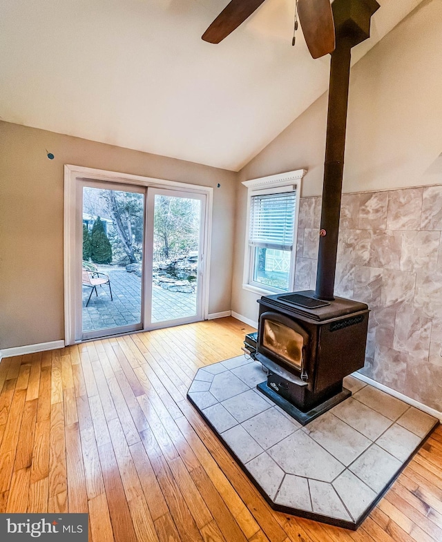 365 Heritage Way, Tuckerton, NJ 08087 - unfurnished living room featuring vaulted ceiling, hardwood / wood-style flooring, a wood stove, and a ceiling fan