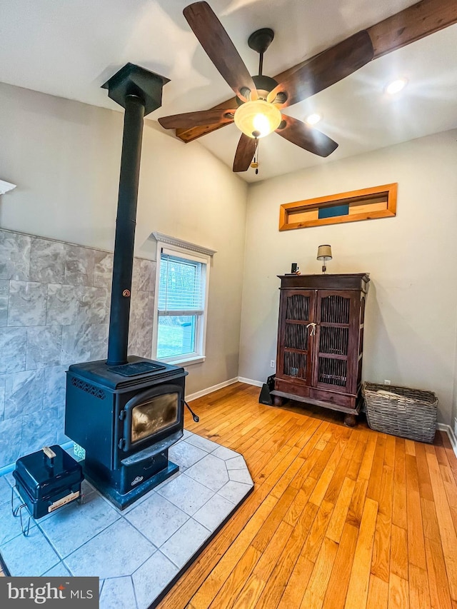 365 Heritage Way, Tuckerton, NJ 08087 - room details featuring a wood stove, a ceiling fan, wood finished floors, and beamed ceiling