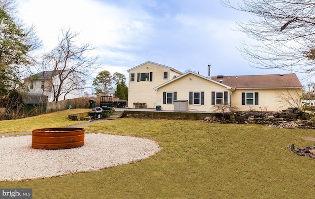 365 Heritage Way, Tuckerton, NJ 08087 - back of property featuring a fire pit, a lawn, a wooden deck, and fence