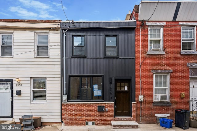 view of property featuring brick siding