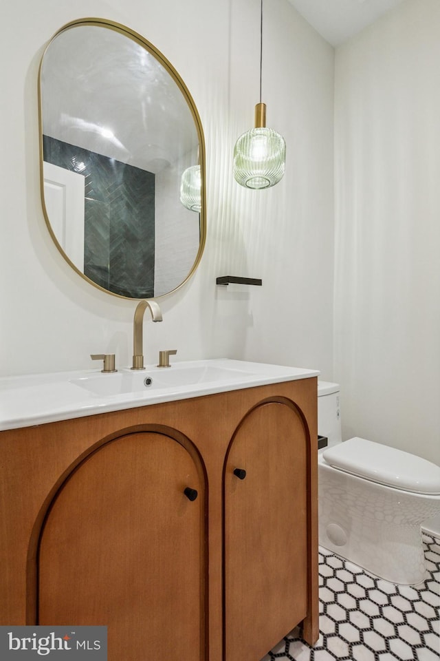 bathroom featuring vanity, toilet, and tile patterned floors