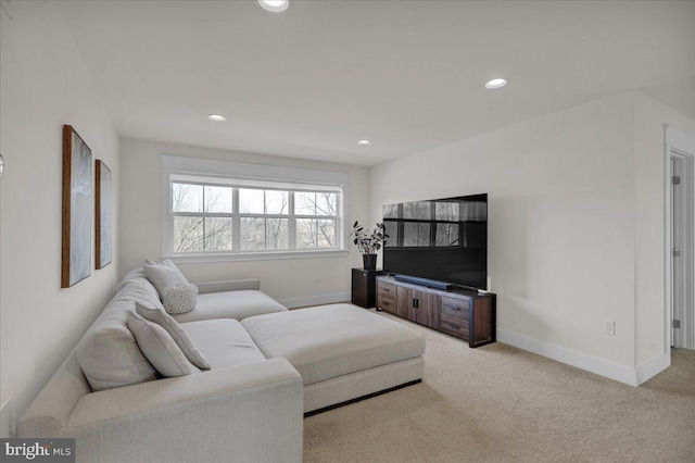 living area with recessed lighting, light colored carpet, and baseboards