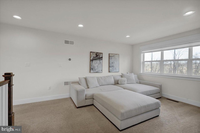 carpeted living room featuring recessed lighting, visible vents, and baseboards