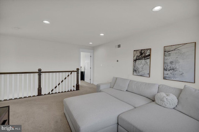 living area featuring carpet, visible vents, and recessed lighting