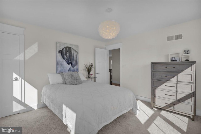 carpeted bedroom with visible vents and baseboards