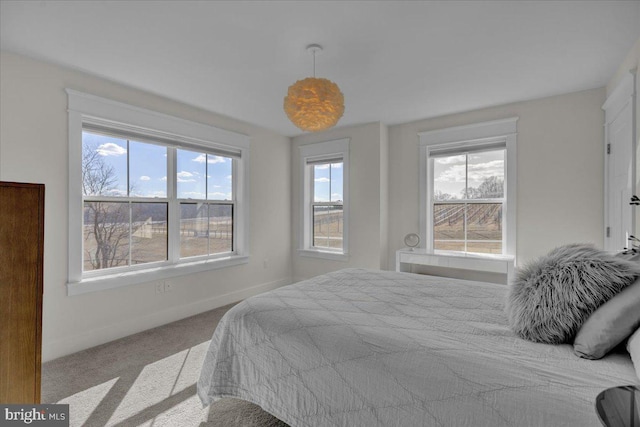 carpeted bedroom featuring baseboards