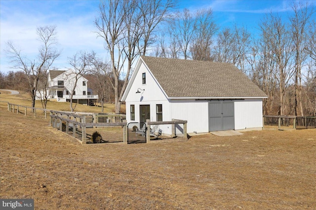 exterior space with fence and an outbuilding