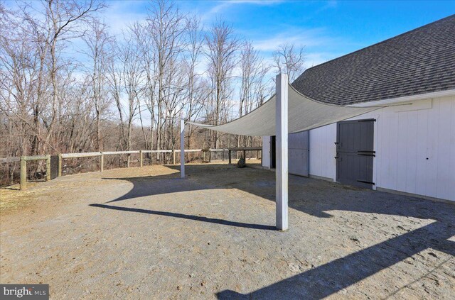 view of yard featuring a carport and fence