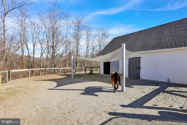 view of yard with fence and an outbuilding