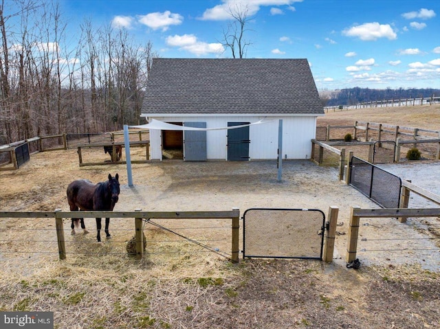 view of stable featuring a rural view