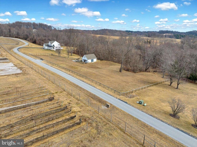 bird's eye view featuring a wooded view and a rural view