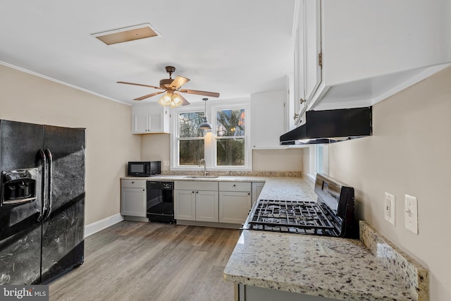 kitchen featuring light wood-type flooring, black appliances, under cabinet range hood, a sink, and ceiling fan