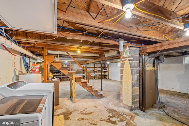 unfinished basement with stairs and washer and clothes dryer