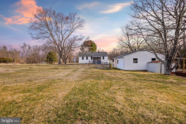 view of yard with an outdoor structure and fence