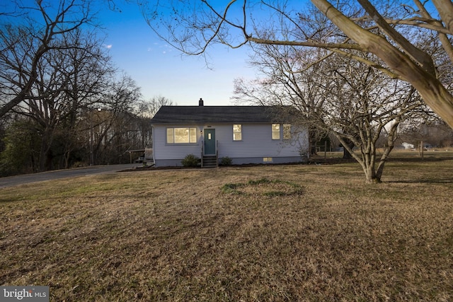 single story home with entry steps, a front lawn, driveway, and crawl space