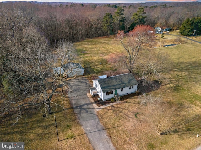 birds eye view of property with a forest view