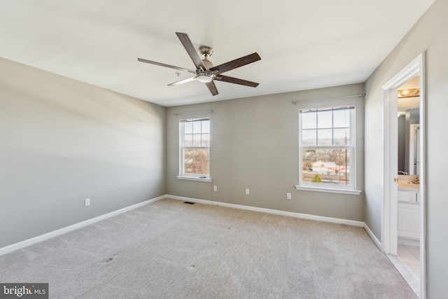 empty room with baseboards, carpet floors, and ceiling fan