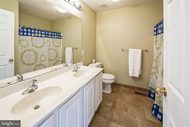 full bathroom featuring double vanity, toilet, visible vents, and a sink