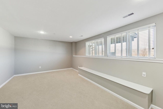 unfurnished room with recessed lighting, visible vents, baseboards, and carpet