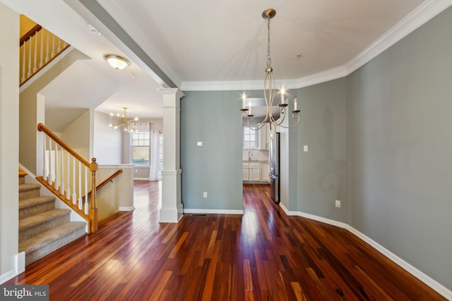 unfurnished dining area featuring baseboards, ornate columns, an inviting chandelier, dark wood-style flooring, and stairs