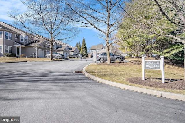 view of road featuring curbs and a residential view