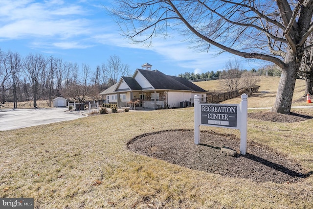 view of front of house featuring a porch, a chimney, and a front yard