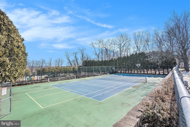 view of tennis court with fence