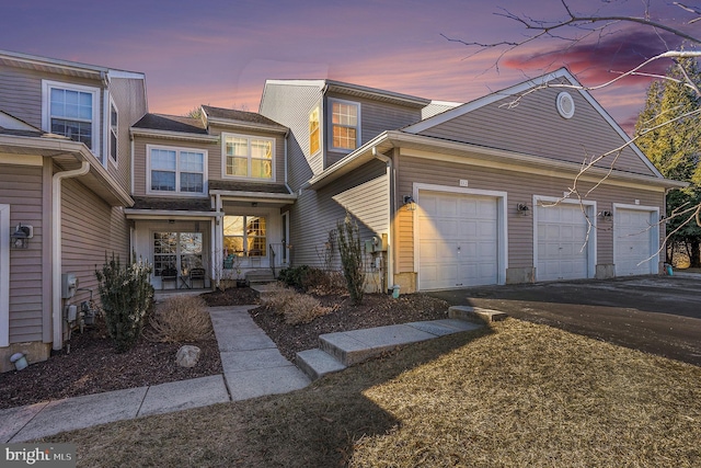 view of front of property with aphalt driveway and an attached garage