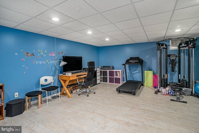 home office with recessed lighting, a paneled ceiling, baseboards, and wood finished floors