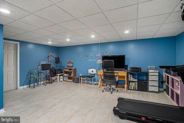 office area featuring recessed lighting, wood finished floors, baseboards, and a paneled ceiling