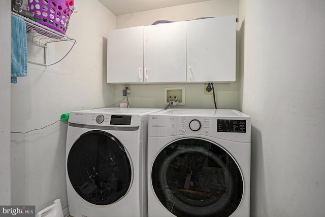 laundry room with cabinet space and washing machine and clothes dryer