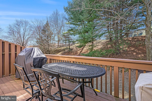 wooden deck featuring outdoor dining area