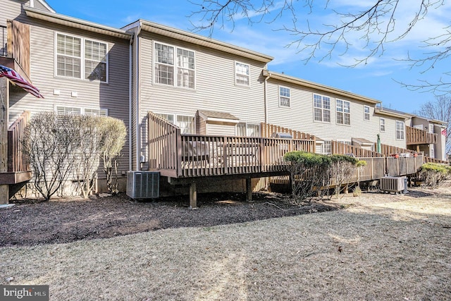 rear view of property with a deck and central air condition unit