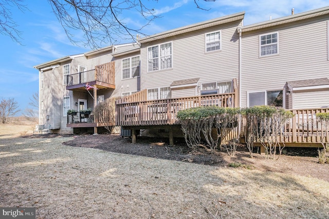 back of house featuring a deck