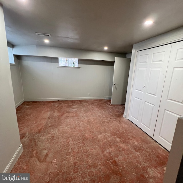 finished below grade area with recessed lighting, visible vents, and baseboards