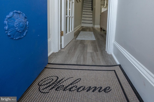 hallway with stairway and wood finished floors