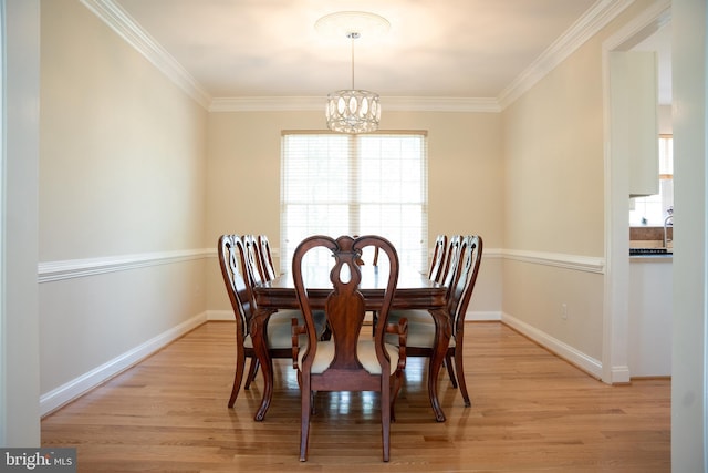 dining space featuring an inviting chandelier, baseboards, and light wood finished floors