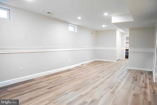 below grade area with light wood-style flooring, recessed lighting, and baseboards