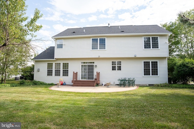 back of house featuring entry steps, a patio, a yard, and a shingled roof