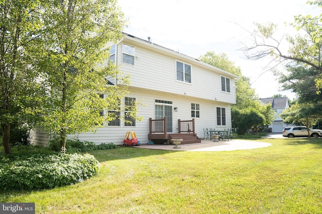 rear view of property featuring a yard and a patio area