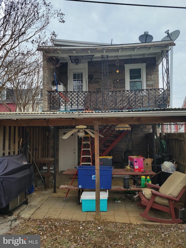 rear view of house with a patio area, fence, and a balcony