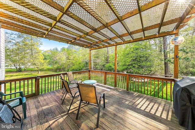 deck featuring grilling area, a pergola, and a yard