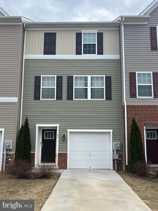 view of property featuring driveway and a garage