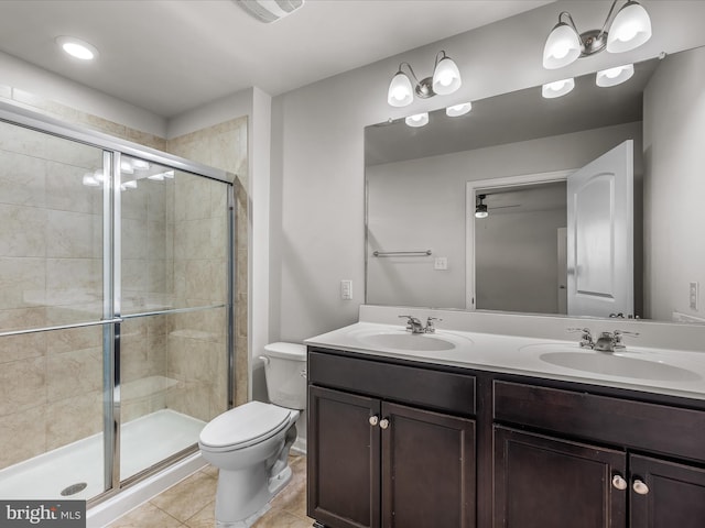 bathroom with a stall shower, tile patterned flooring, a sink, and double vanity