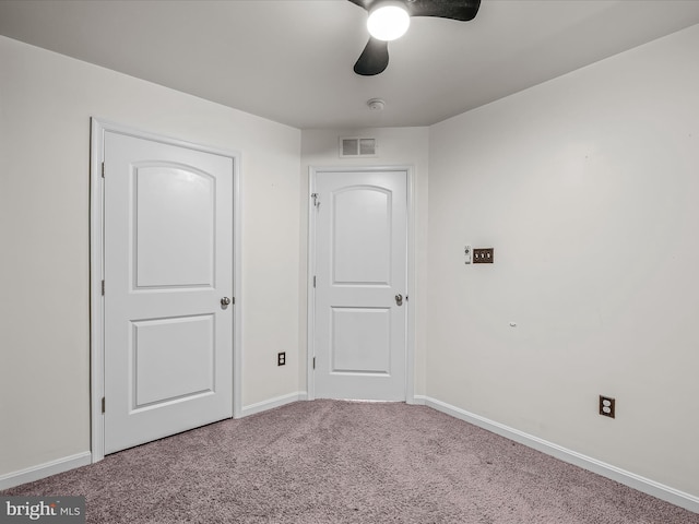 empty room with a ceiling fan, baseboards, visible vents, and carpet flooring